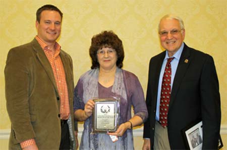 Jerry Gustin of Gustin Land and Cattle, right, and his wife, Karen, accept the Virginia Angus Association Cattlemen/Seedstock Producer of the Year Award from Peter Henderson, Secretary of the Southside Virginia Angus Association.